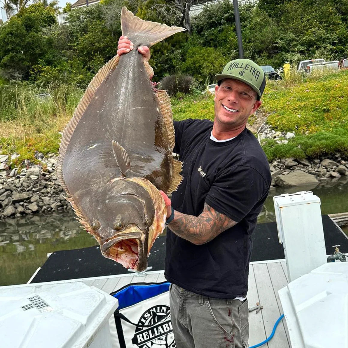 Green Kalletka Arch Logo hat with a barn door halibut