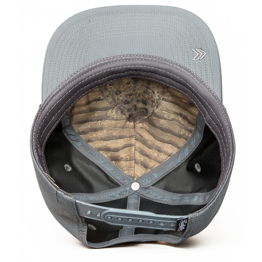 The back view of a gray structured baseball cap with a interior Halibut art panel inner lining and an adjustable hook-and-loop strap closure, shown on a white background.