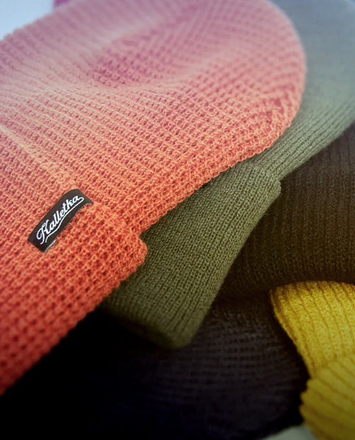 Close-up of colorful knit fabric with a brand label.